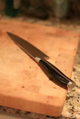 Chef knife laid flat on a board