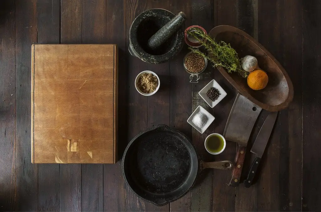 Kitchen tools, herbs and spices laid out on the workshop bench